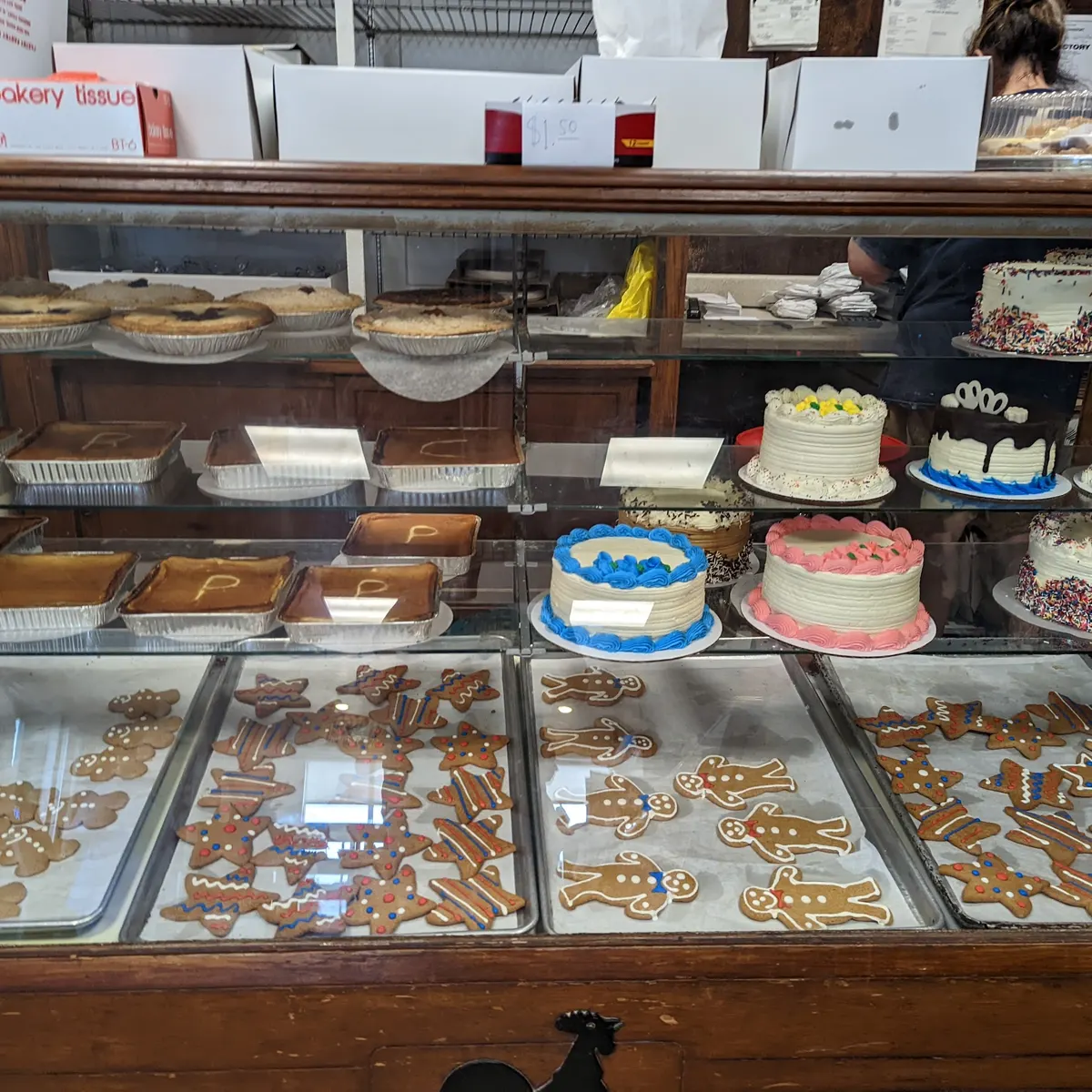 Decorated cakes, pies and gingerbread cookies in Chester's bakery case
