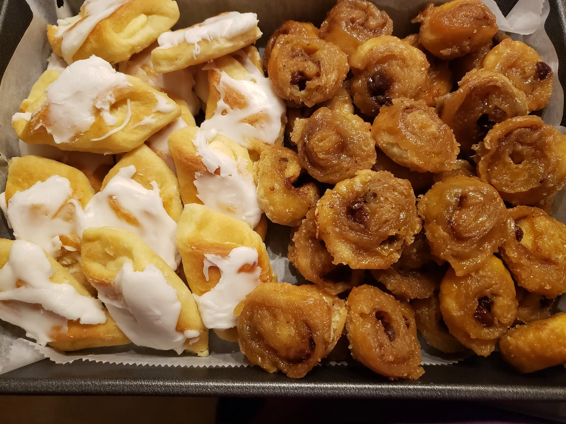 A tray of iced Danish pastries and golden honey buns from Chester's Pastry Pantry Bakery